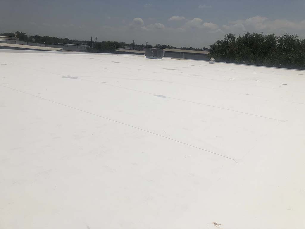 Commercial flat roof replacement completed by Redline Roofing - new low-slope roofing system installed in East Texas