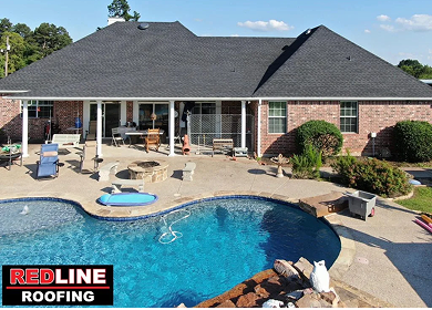 Aerial drone view of new shingle roof replacement on luxury home with pool near Tyler, TX