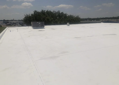 Completed white TPO commercial roof replacement on flat commercial building, Tyler TX