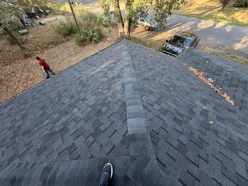 Completed shingle roof with clean valley and ridge lines on a Gladewater, TX residence