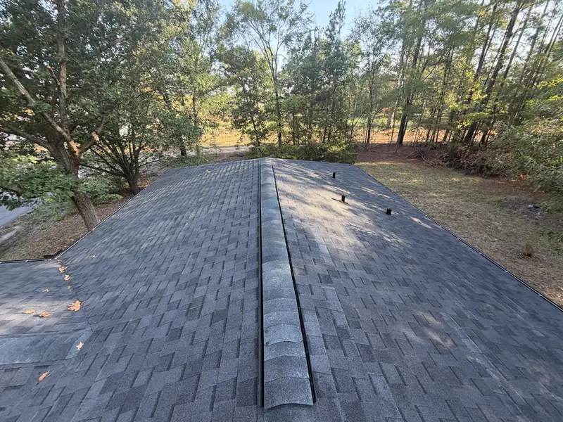 Ridge cap shingles and vent detail on a newly replaced roof in Gladewater, TX