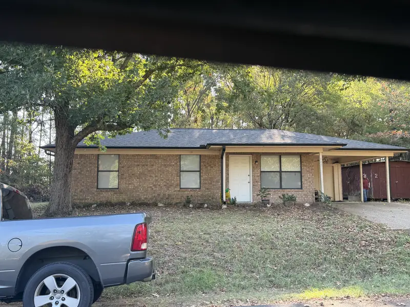Same Gladewater, TX brick ranch home after a complete architectural shingle roof replacement