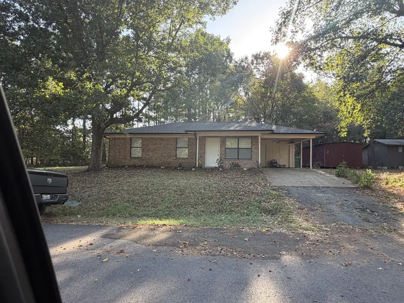 Brick ranch home in Gladewater, TX with a worn original shingle roof before replacement
