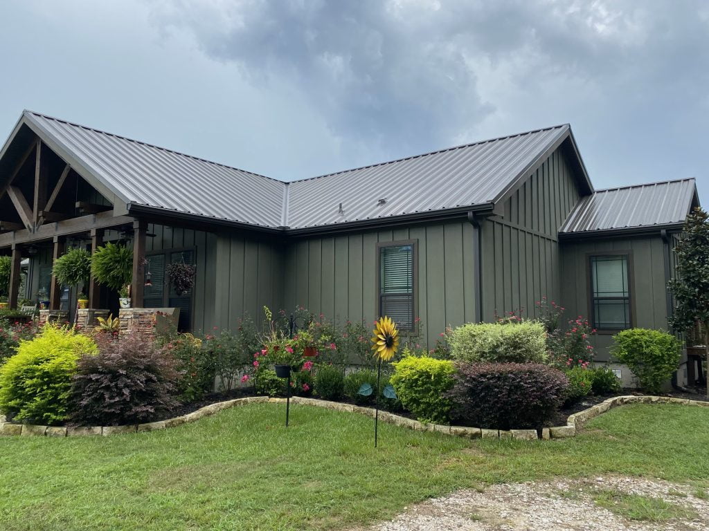 green house with grey metal roof