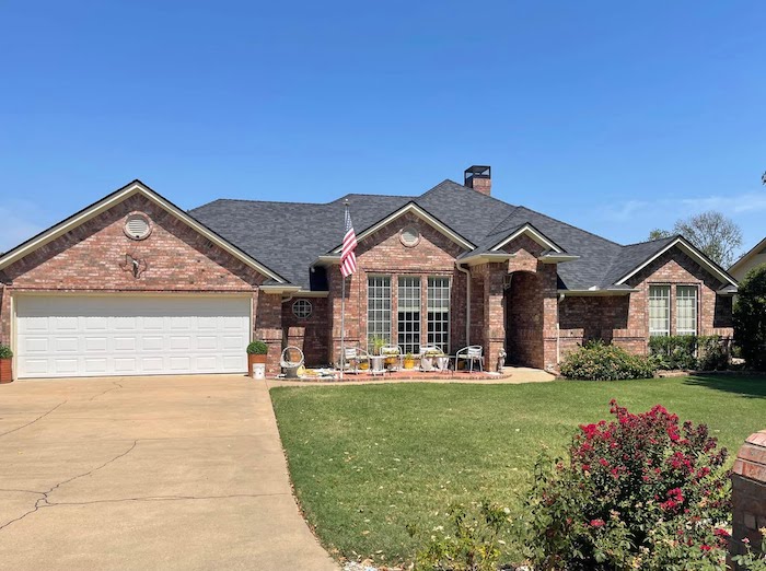 brick house with new roof installed by Redline Roofing in Tyler Texas